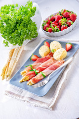 asparagus ham rolls with strawberries and hollandaise