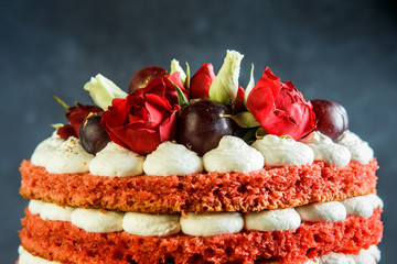 closeup top of beautiful cake with bizet, grapes and roses