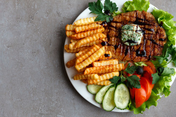 French fries steak vegetables salad