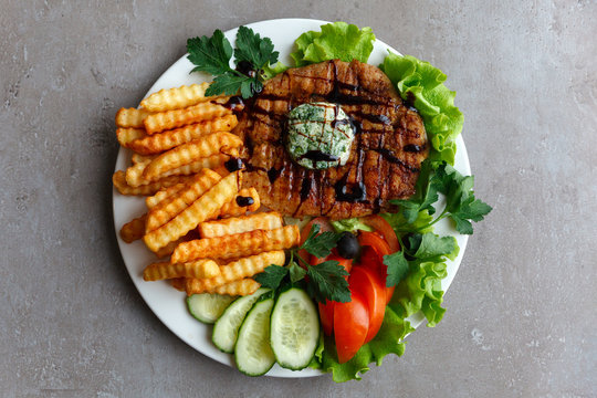 French fries steak vegetables salad
