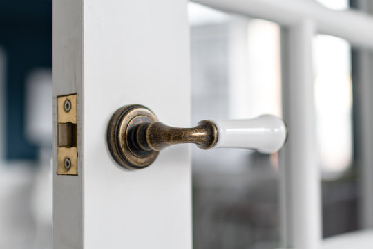 Beautiful Modern Door Knob. Open, Wooden Front Door From The Interior Of An Upscale Home With Windows.