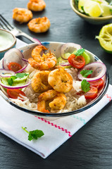 Tandoori prawn skewers with rice and chopped salad - high angle view