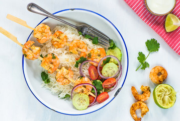 Tandoori prawn skewers with rice and chopped salad - top view