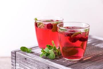 Aperitif with campari, mint and raspberry. Iced lemonade