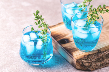 Ice Blue cocktail with thyme. Blue curacao liqueur. Summer