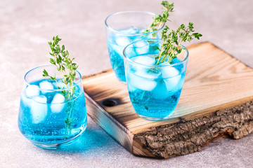 Ice Blue cocktail with thyme. Blue curacao liqueur. Summer