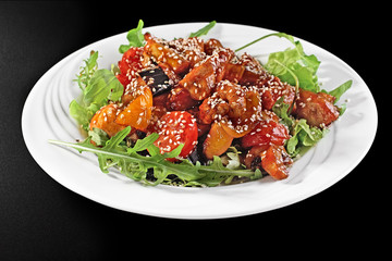 Grilled chicken breast and summer vegetables close-up on a plate on a table. horizontal view from above