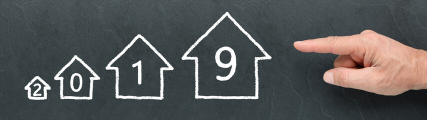 Different Size Houses and 2019 on a blackboard