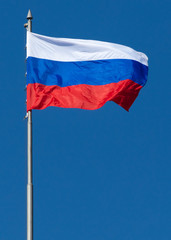 Naklejka na ściany i meble Flag of the Russian Federation against the blue sky