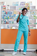 African american pharmacist working in drugstore at hospital pharmacy. African healthcare. Stethoscope on black woman doctor.