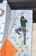 the teenager trains on the climbing wall