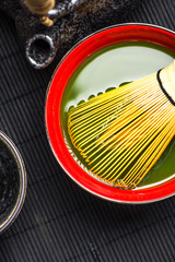 Traditional bamboo whisk and matcha tea