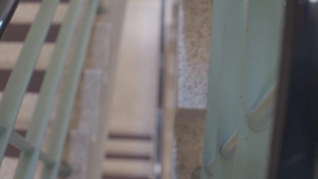 woman walks down spiraling building staircaise