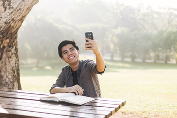 Young man taking selfie at a park