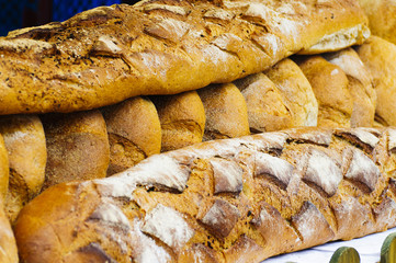 Fresh crispy bread lies on the counter at the traditional street fair in Europe