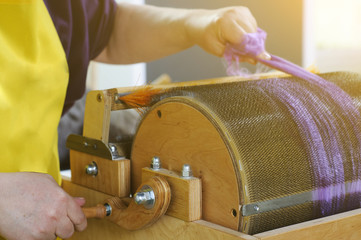 Felting wool. The step of combing the material in a special carding machine.