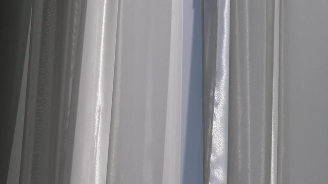 Window with a curtain tulle fluttering. Conceptual romantic story of the room and open Windows.   