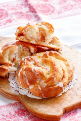 Fresh homemade sweet cinnamon swirl bun with glaze. Selective focus.