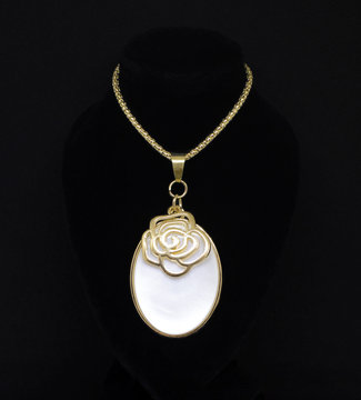 Gold necklace with bronze rose choker on white isolated on black