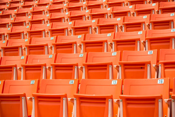 Fototapeta premium Many orange chairs in football stadium.
