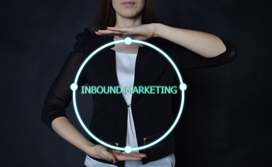 In the hands of a businessman, a neon circle with the inscription:INBOUND MARKETING