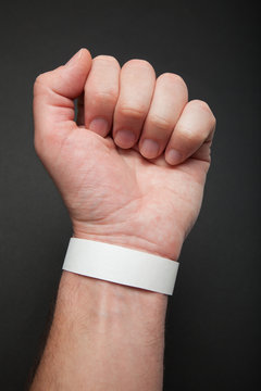 White concert paper bracelet on hand, mockup. Wristband accessory adhesive.