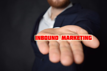 In the hands of a businessman the inscription:INBOUND MARKETING