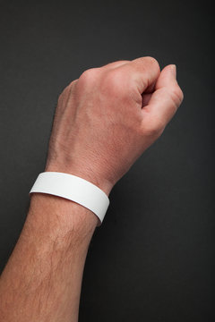 White round bracelet on hand, mockup. Arm wristband accessory adhesive blank.