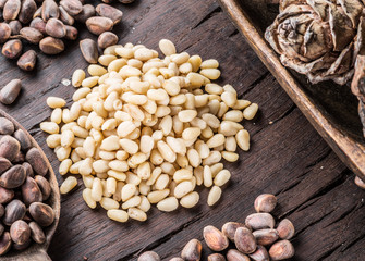 Pine nuts on the wooden table. Organic food. Top view.