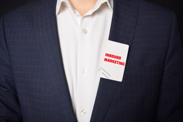 Businessman shows business card with the inscription:INBOUND MARKETING