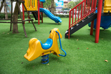 Rocking horse on children playground in the city