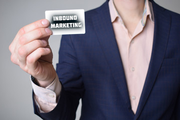 Businessman shows business card with the inscription:INBOUND MARKETING