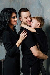 young family having fun at home on a background of a vintage textured wall.