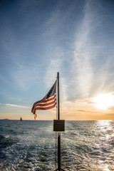 American flag flying from of a boat at sea