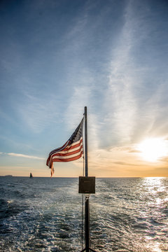 American flag flying from of a boat at sea