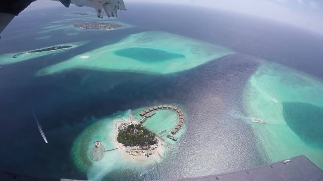 Aerial View From Airplane Window On Maldivian Islands. With Parts Of The Plane In The Shot