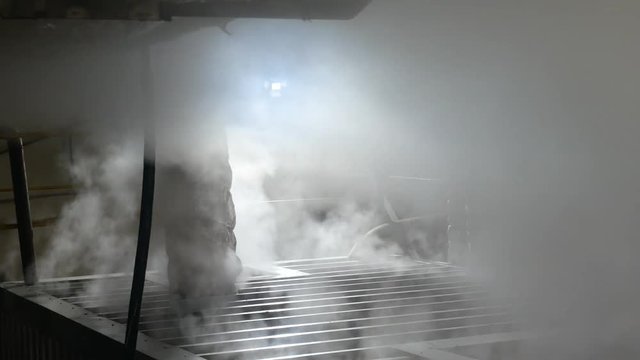 Hot steam on sugar refinery plant indoors