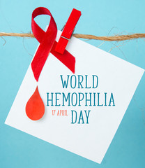Awareness poster with red paper cut blood drop and red ribbon symbol . Blood donor day or World...