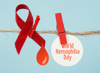 Awareness poster with red paper cut blood drop and red ribbon symbol . Blood donor day or World...