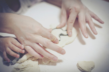 Hands form the shape of the dough.