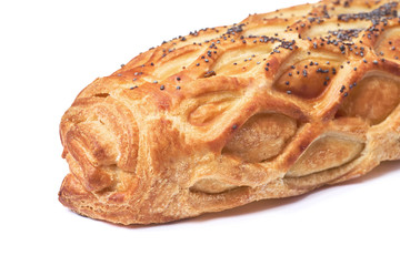 Baked bun with puff pastry sprinkled with poppy seeds isolated on white background.