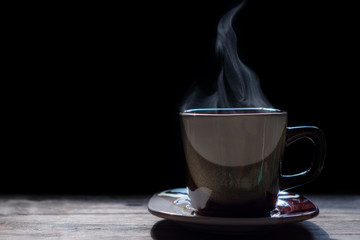 Hot coffee on the wooden table.