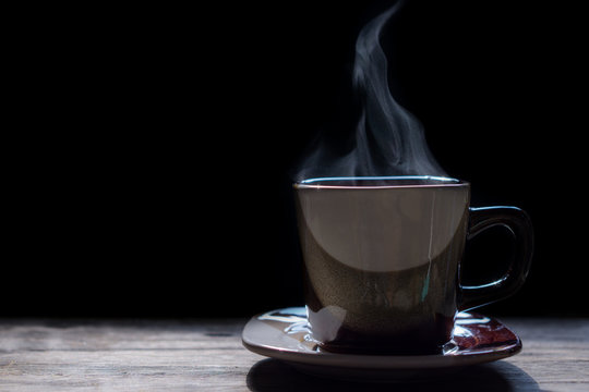Hot coffee on the wooden table.