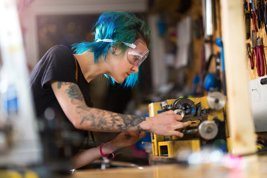 Confident young woman working in workshop
