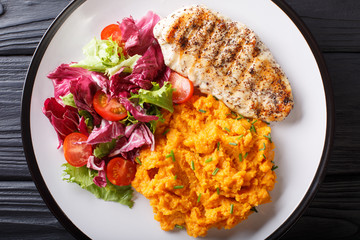 Grilled chicken with mashed potatoes and fresh salad closeup. horizontal top view