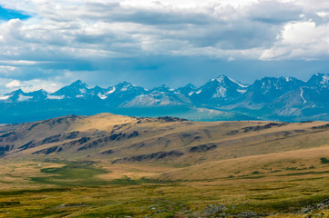 Mountain landscape with clouds. Mountain valley. The Altai mountains. Travel adventure vacation background