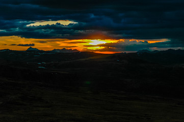 Mountain landscape with clouds. Mountain valley. The Altai mountains. Dramatic sunset in the mountains. Travel adventure vacation background