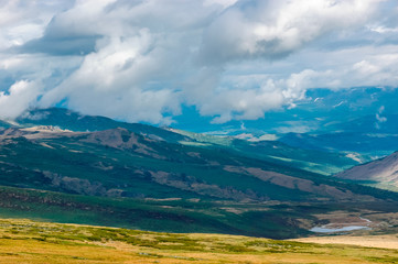 Mountain landscape with clouds. Mountain valley. The Altai mountains. Travel adventure vacation background