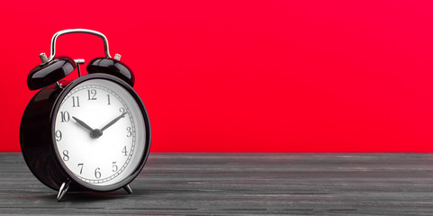 alarm clock wooden plank colored background