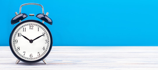 alarm clock wooden plank colored background